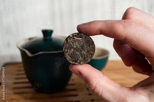 Sheng Puer pressed into a circle in hand photo