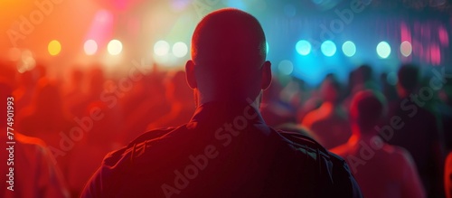 A man addressing a crowd at a concert photo