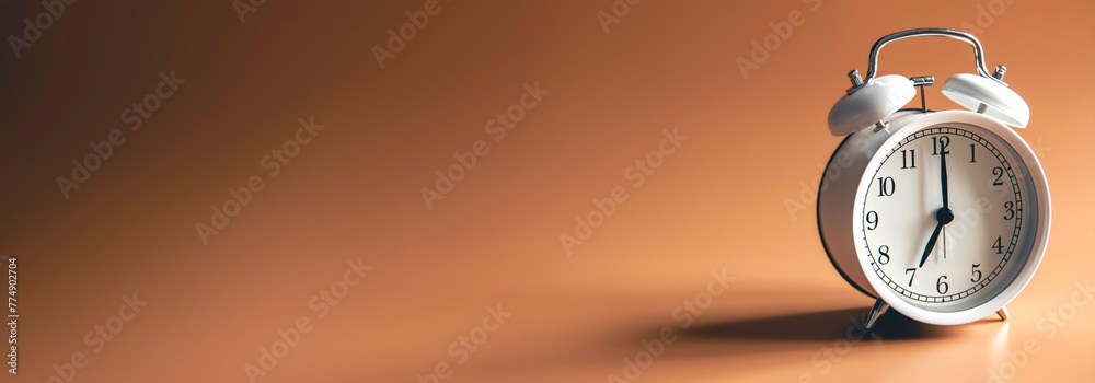 White alarm clock on brown background isolated. White alarm clock on brown background isolated.