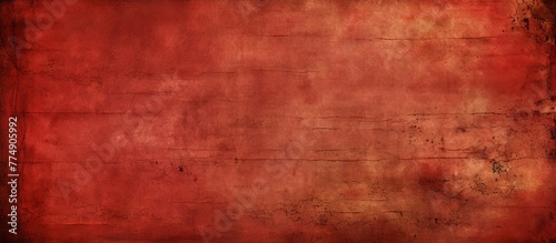 A red grungy background with a faded and worn surface creating a textured and weathered look