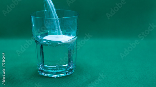 glass with water and medicine powders