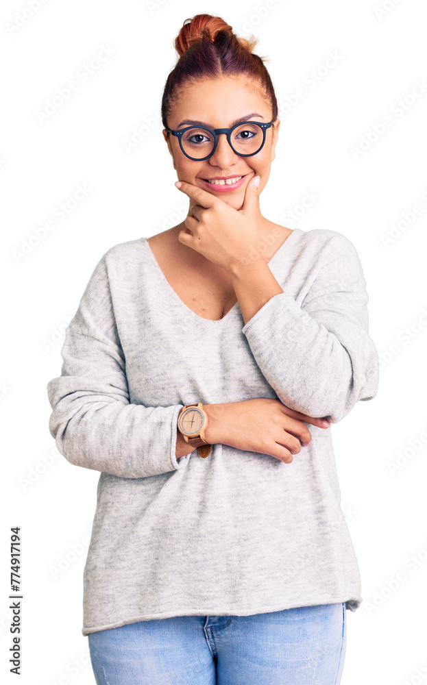 Young latin woman wearing casual clothes looking confident at the camera smiling with crossed arms and hand raised on chin. thinking positive.
