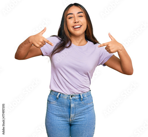 Young latin woman wearing casual clothes looking confident with smile on face, pointing oneself with fingers proud and happy.