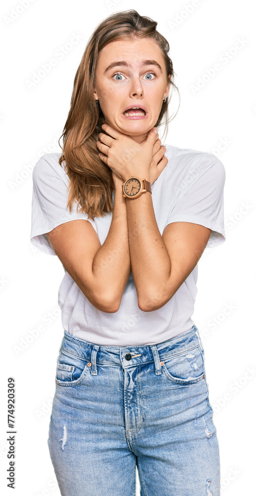 Beautiful young blonde woman wearing casual white t shirt shouting suffocate because painful strangle. health problem. asphyxiate and suicide concept.