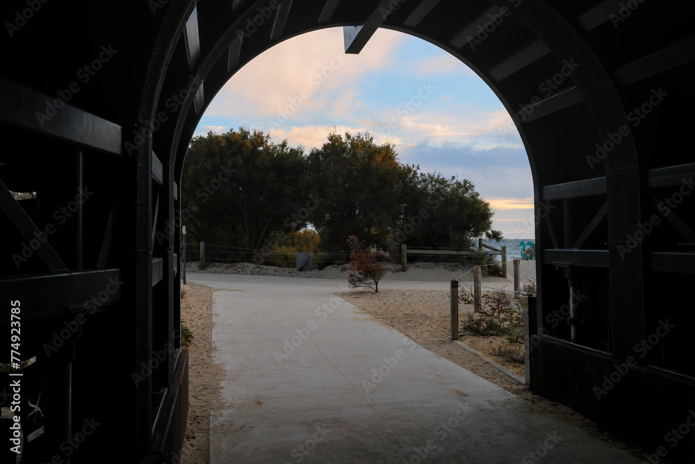 Entrance to historic whaling tunnel in Fremantle, forming a frame for the onset of sunset colors in the sky. Perth, Western Australia.