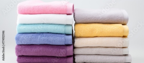 Colorful towels neatly stacked in a close-up view, displaying a variety of vibrant shades and hues