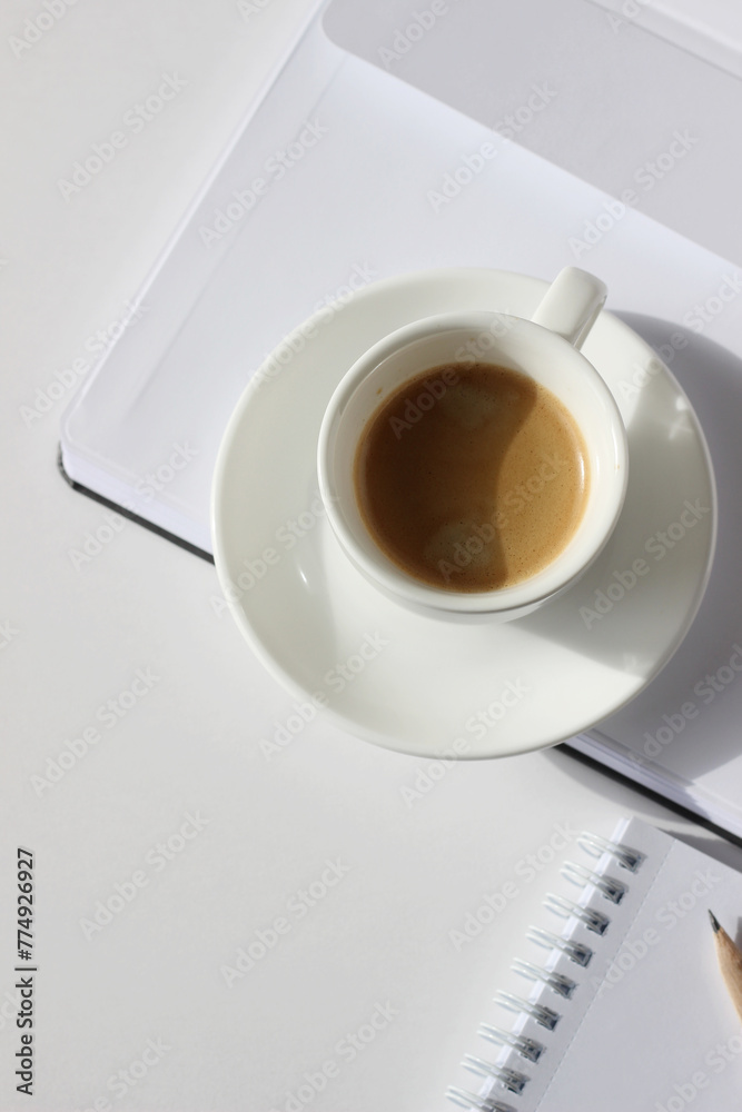 Drinking Coffee at Workplace. Fresh Espresso on Open Notebook, Spiral Notebook with Pencil. Business Flatlay.