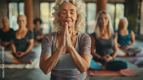 Pilates, wellness and group of senior women doing a mind, body and spiritual exercise in studio. Health, retirement and elderly friends doing yoga workout in zen class for peace, balance and fitness
