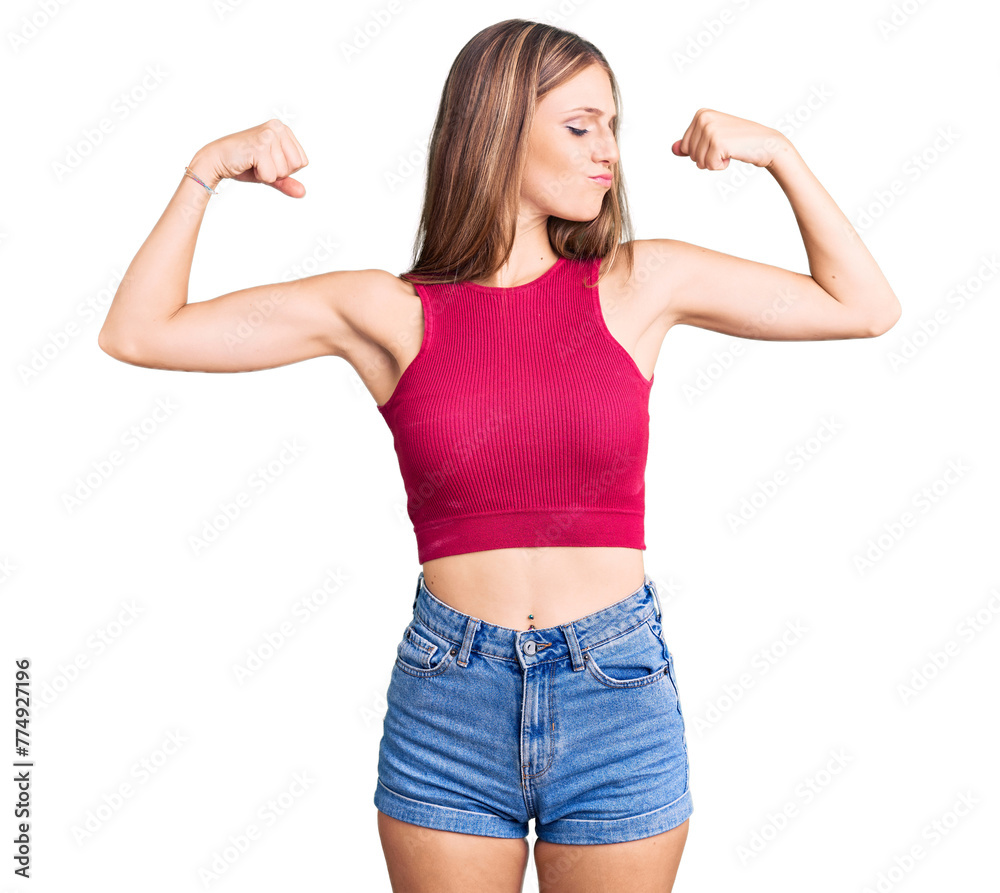 Young beautiful blonde woman wearing elegant summer shirt showing arms muscles smiling proud. fitness concept.