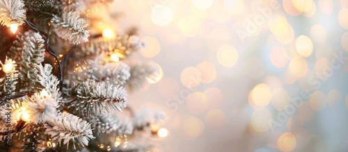 A close up of a Christmas tree with lights in the background