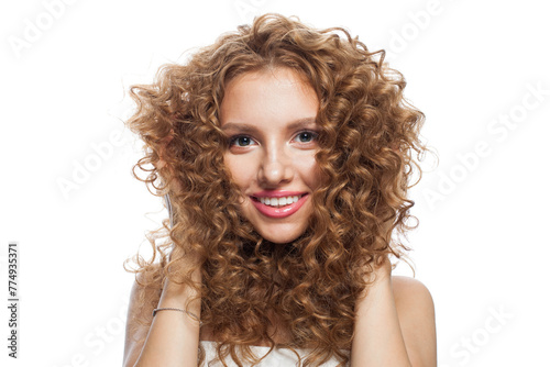Gorgeous fashion model with frizzy hair, natural makeup and healthy clean skin posing on white background. Skincare, haircare and cosmetology concept