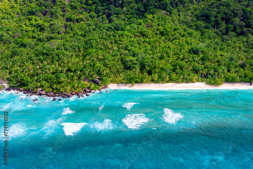 beautiful tropical beach with sea and palm trees taken from drone. Seychelles. Vacation holidays