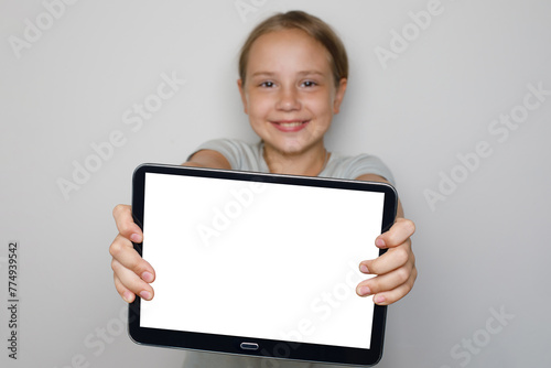 Blank empty tablet display in hands of beautiful cute child girl