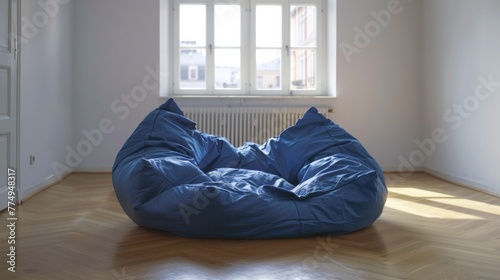 A bean bag chair sitting in front of a window on an empty floor, AI © starush
