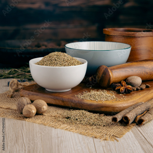 Ajwain Carom Seeds. Spice on wooden table background. Herbs, spices and dried food baking ingredient. Mortar and different spices. Cottage kitchen concept nourishment, and nature and culture. photo