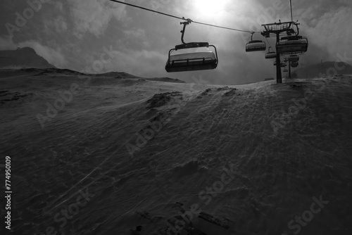 Ski Lift on a stormy day goiing up the mountain, black and white