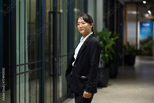 Portrait Smiling confident young business woman standing at home office. looking at camera arms crossed