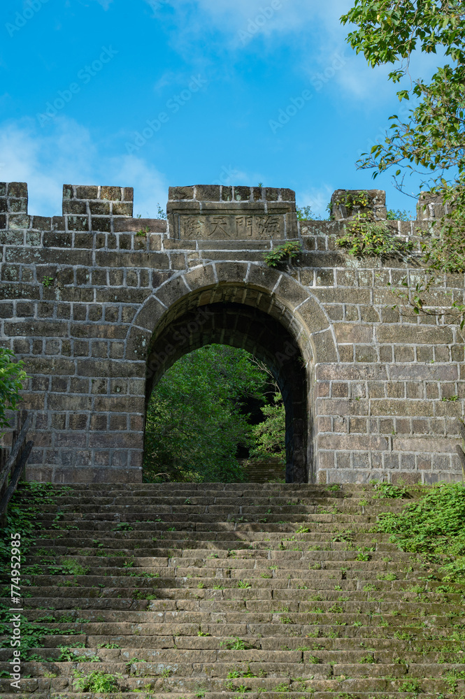 Historic stone gate build in Qing dynasty, hidden in the Ershawan Fort (national historic site), the title in Chinese means tenable gate of the sea, in Keelung city, Taiwan. Historic stone gate build in Qing dynasty, hidden in the Ershawan Fort (national historic site), the title in Chinese means tenable gate of the sea, in Keelung city, Taiwan.