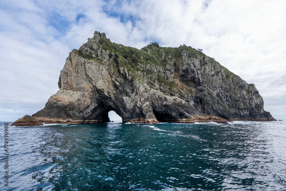 Fototapeta premium Landscape view with of a hole in the rock, Piercy Island, New Zealand