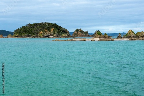 Sunlit seascape view with cloudy sky background, Bay of islands