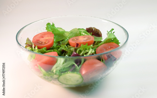 fresh vegetable salad in a transparent plate frillis cucumber tomato