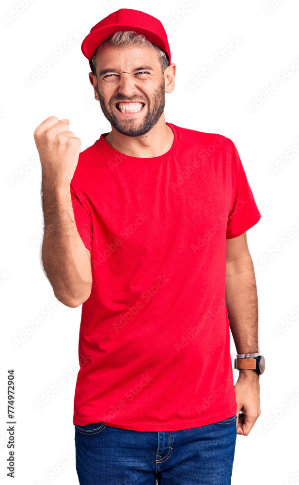 Young handsome blond man wearing t-shirt and cap angry and mad raising fist frustrated and furious while shouting with anger. rage and aggressive concept. Young handsome blond man wearing t-shirt and cap angry and mad raising fist frustrated and furious while shouting with anger. rage and aggressive concept.