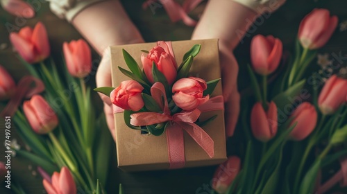 A precious gift box with tulips and ribbon being cra  AI generated illustration photo