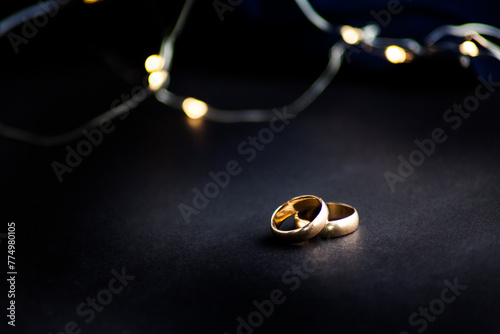 two wedding  rings on a black  with space 