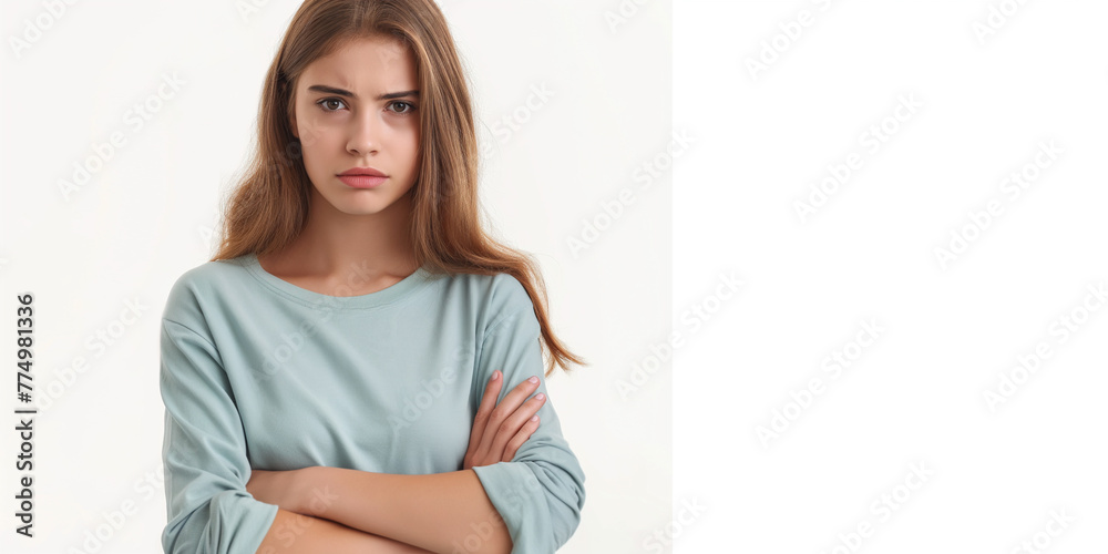 Portrait of an upset young casual girl standing with arms folded isolated over white background High resolution professional photography Portrait of an upset young casual girl standing with arms folded isolated over white background High resolution professional photography