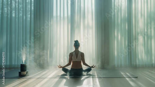 Woman practicing yoga in peaceful home environment, meditation with sunlit curtains and diffuser