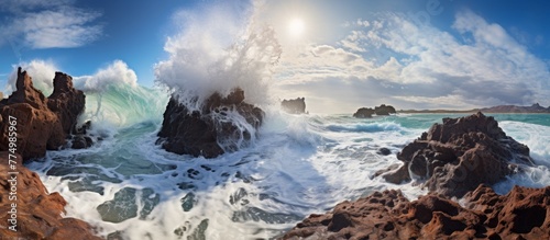 A powerful ocean wave colliding forcefully with the rugged, rocky coastline