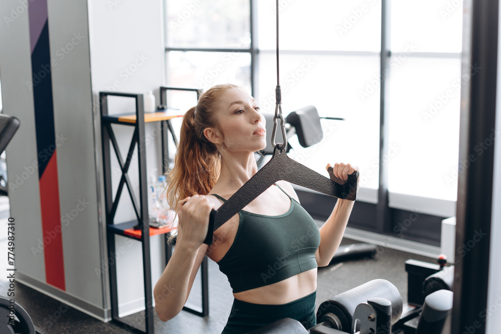 Fototapeta premium woman trains in fitness gym