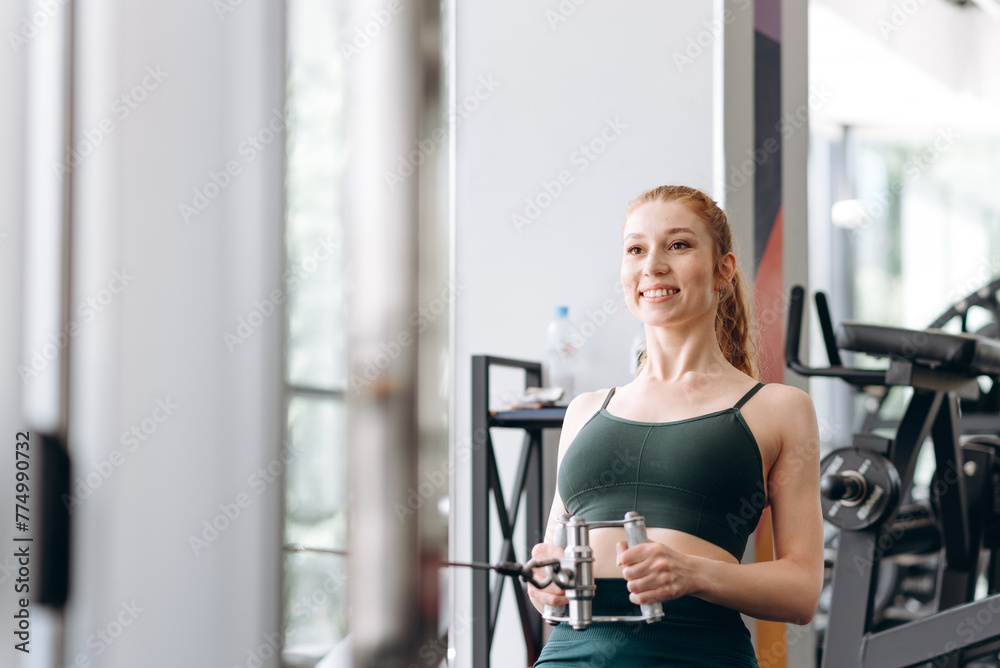 Fototapeta premium woman trains in fitness gym