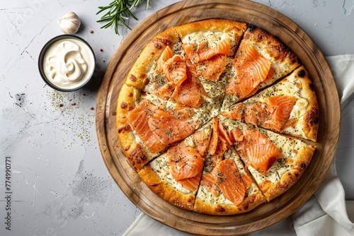 a pizza with salmon slices on a wooden plate © White