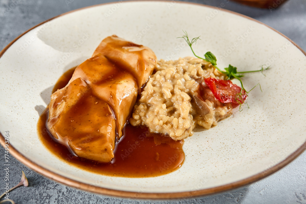 Grilled Chicken Breast with Mushroom Risotto Drizzled with Gravy on a Speckled Plate Grilled Chicken Breast with Mushroom Risotto Drizzled with Gravy on a Speckled Plate