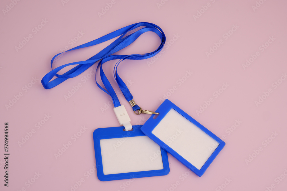 Blue blank plastic badges with space for text on pink background Blue blank plastic badges with space for text on pink background