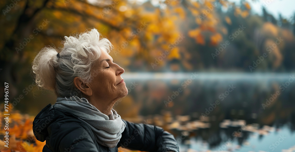 Senior woman doing yoga in a serene park, wearing modern athletic wear, surrounded by autumn leaves, a tranquil lake in the background, peaceful and focused atmosphere Senior woman doing yoga in a serene park, wearing modern athletic wear, surrounded by autumn leaves, a tranquil lake in the background, peaceful and focused atmosphere