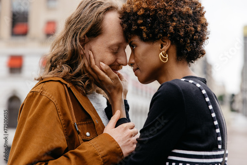 Affectionate woman embracing her partner on a city street, sharing a sweet loving moment photo