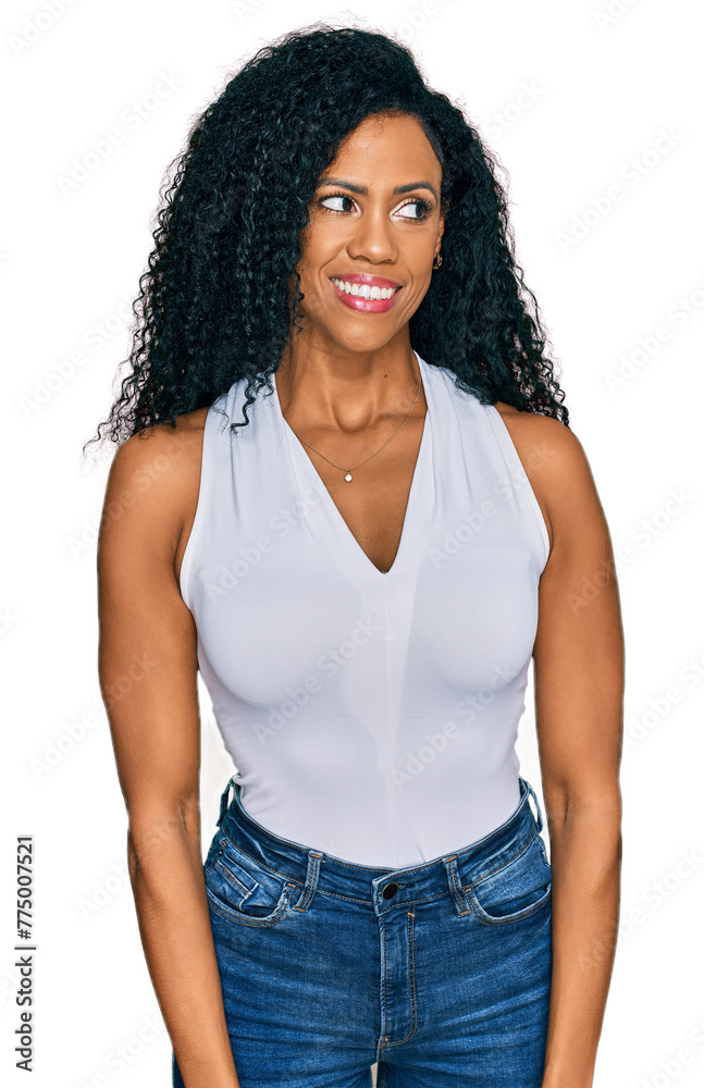 Middle age african american woman wearing casual style with sleeveless shirt smiling looking to the side and staring away thinking. Middle age african american woman wearing casual style with sleeveless shirt smiling looking to the side and staring away thinking.