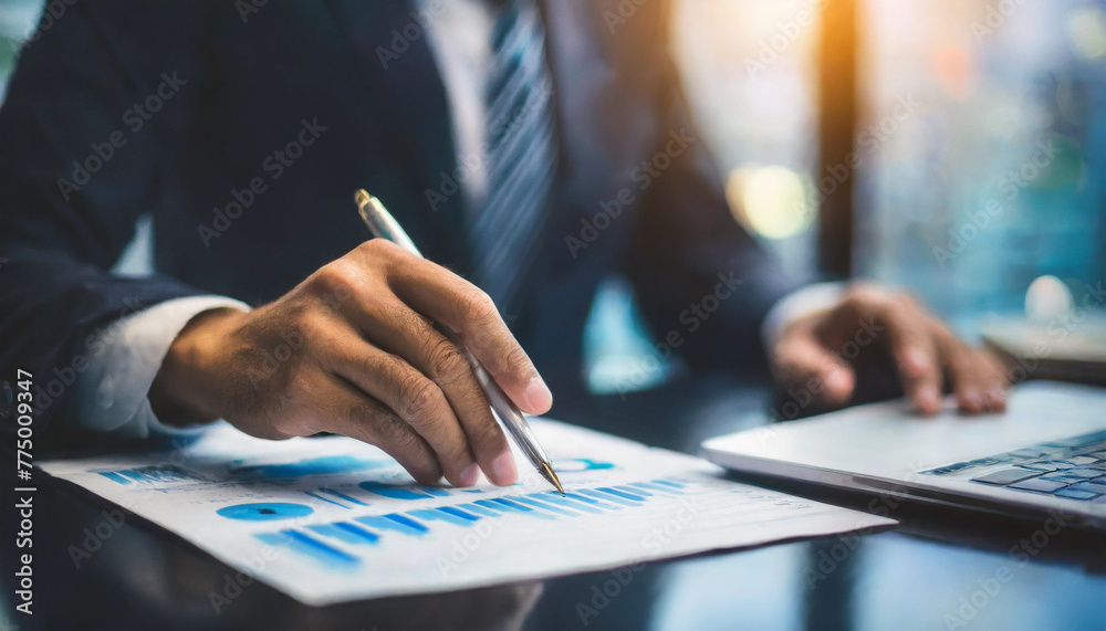 business advisor analyzing finances, hand in focus with backlight business advisor analyzing finances, hand in focus with backlight