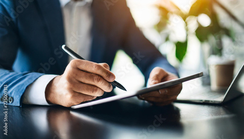 Businessman signs e-doc on tablet with stylus pen, symbolizing efficiency & modern business photo