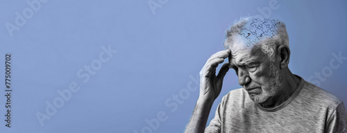 Elderly senior old thinking man suffering from dementia with puzzles on head