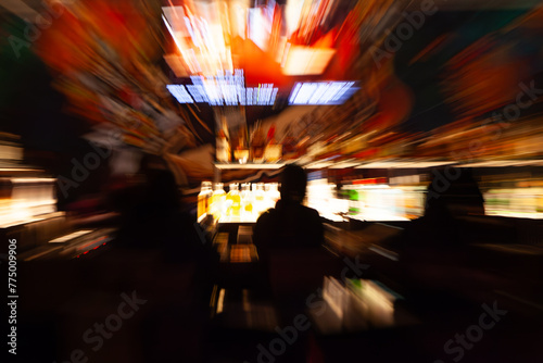 Abstract of people playing slot machines in casino