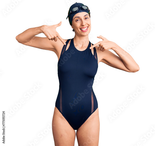 Принти на полотні Young beautiful hispanic woman wearing swimwear and swimmer glasses looking confident with smile on face, pointing oneself with fingers proud and happy