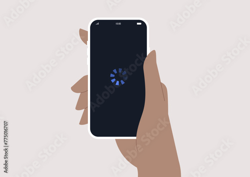Hand Holding a Mobile Phone displaying a loading symbol, indicating a system freeze or delay