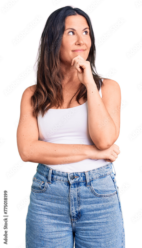Young beautiful brunette woman wearing casual sleeveless t-shirt with hand on chin thinking about question, pensive expression. smiling with thoughtful face. doubt concept. Young beautiful brunette woman wearing casual sleeveless t-shirt with hand on chin thinking about question, pensive expression. smiling with thoughtful face. doubt concept.