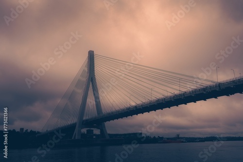 Low-angle of the Anzac bridge against cloudy and purple sky