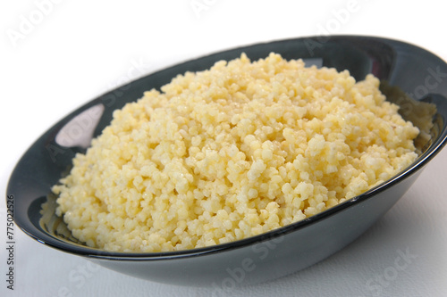 groats in plate on white