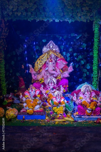 Vertical shot of the statue of Lord Ganesh at mandal in Mumbai for the festival of Ganesh Chaturthi © Wirestock