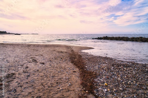 Wallpaper Mural Closeup of a rocky beach with the tranquil seascape under the beautiful sunset sky Torontodigital.ca